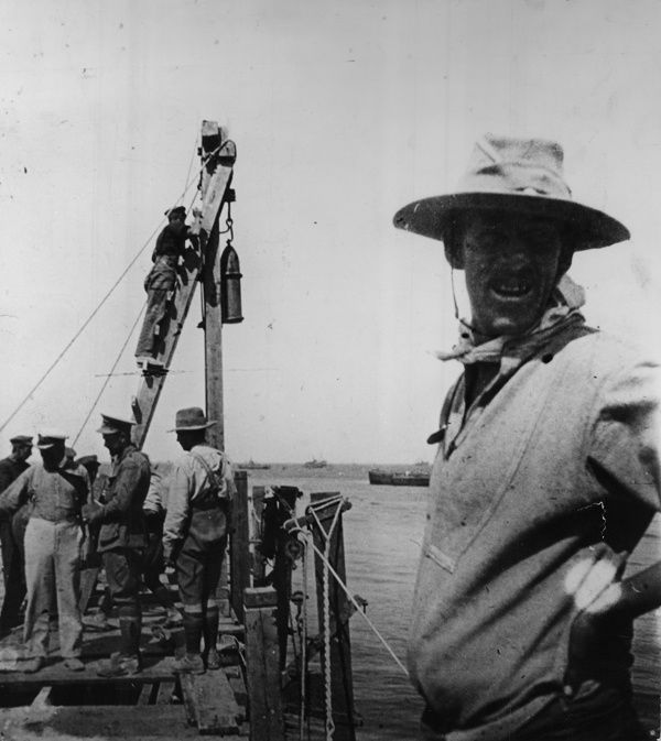 Sappers constructing Watson's Pier using a spent shell as a piledriver